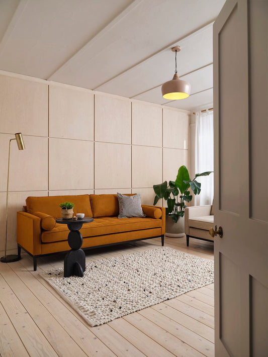 orange sofa with black side table